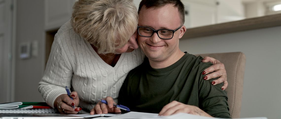 Woman hugging man with Down Syndrome