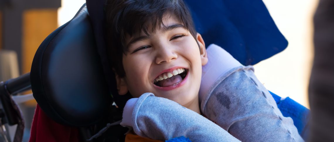 Smiling young boy in wheelchair