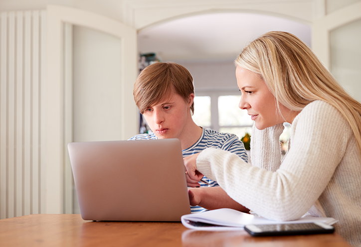 Woman on computer with young boy